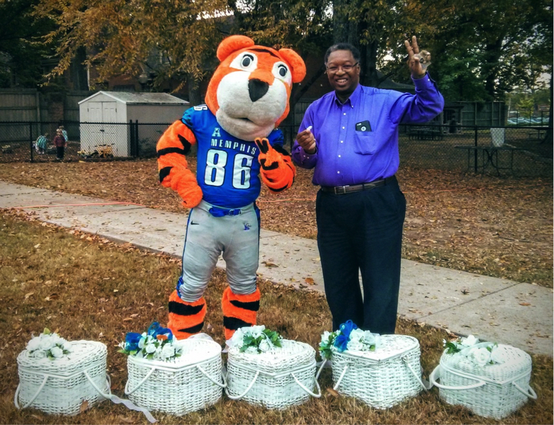 Dr. Moore with Pouncer, the University of Memphis Tigers mascot, before release of the 24 Peace Doves from their baskets, during 2015 Peace Day at the Lipman School. Photo courtesy Sandra Brown Turner.